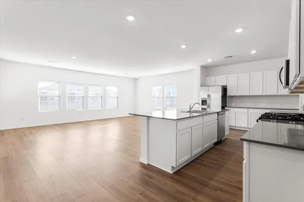a kitchen with stainless steel appliances granite countertop a sink and cabinets