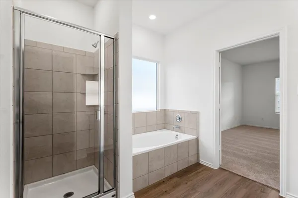 a bathroom with a bathtub and shower