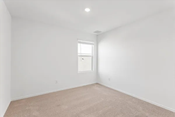 a view of an empty room and a window
