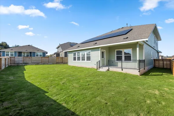 a view of a house with a backyard