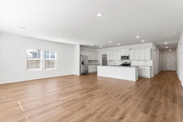 a view of kitchen view wooden floor and window