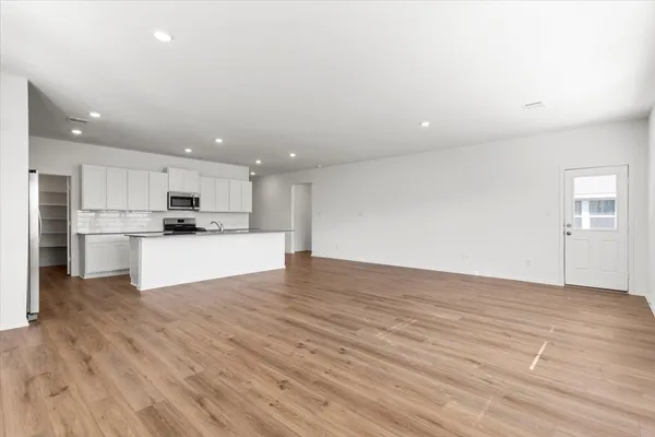 a view of kitchen with wooden floor and window
