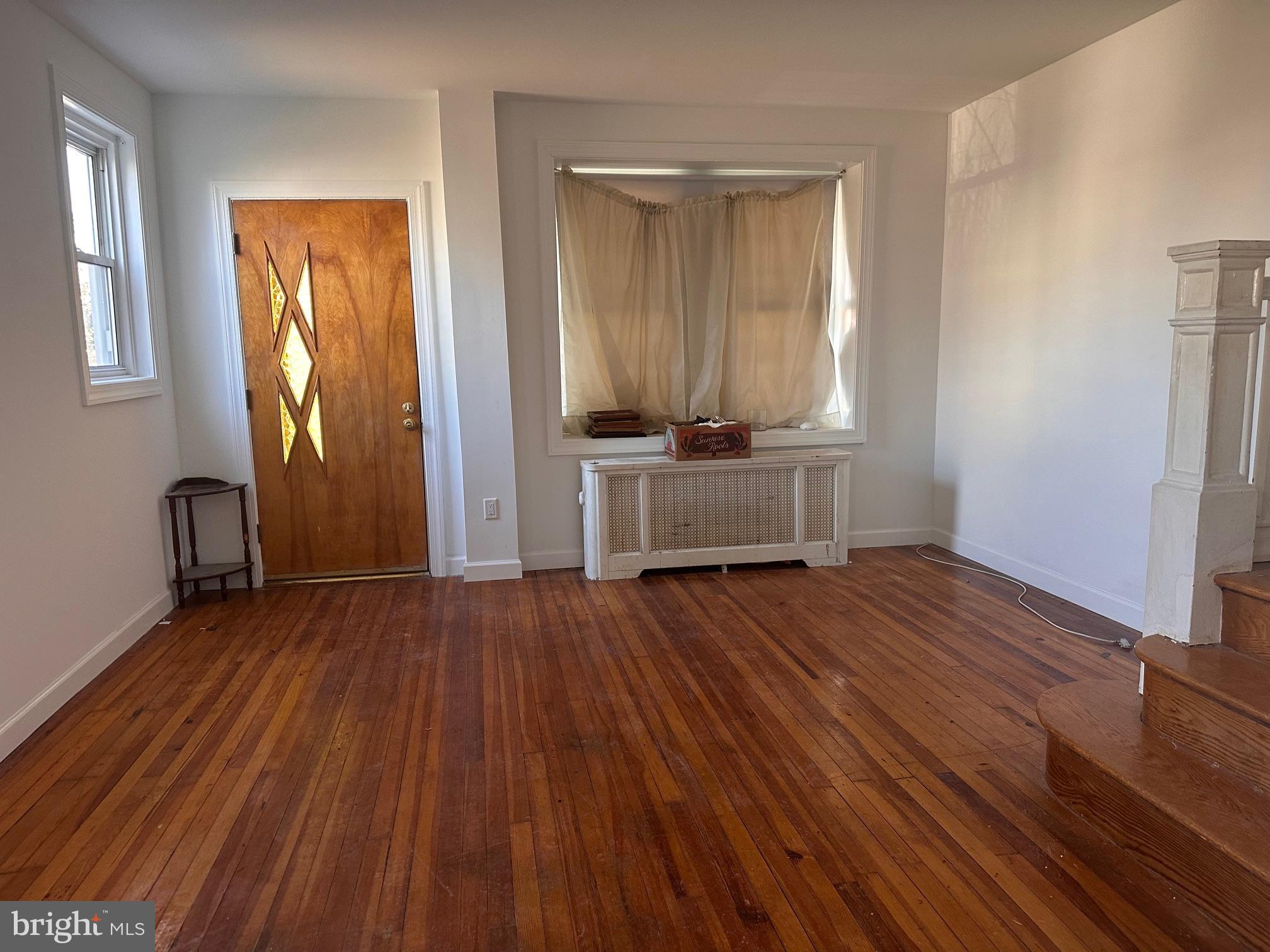 402 Walter Street Philadelphia, PA 19111 - Photo 3 of 15 an empty room with wooden floor and windows