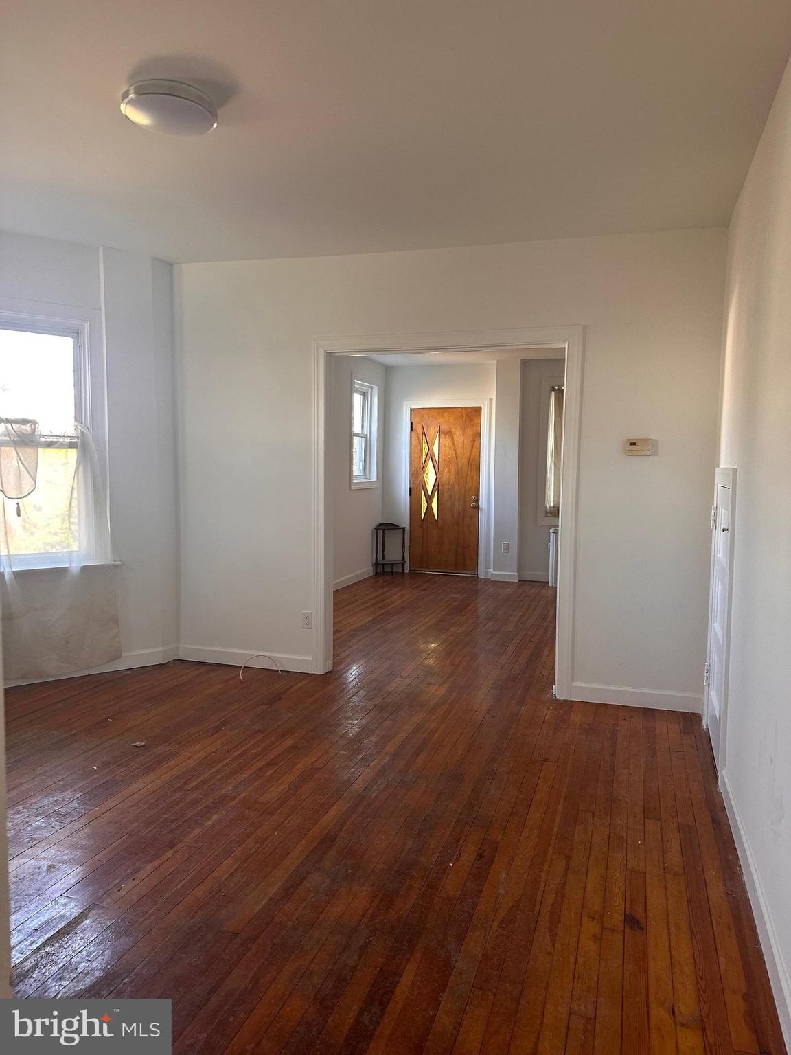 402 Walter Street Philadelphia, PA 19111 - Photo 4 of 15 an empty room with wooden floor and windows