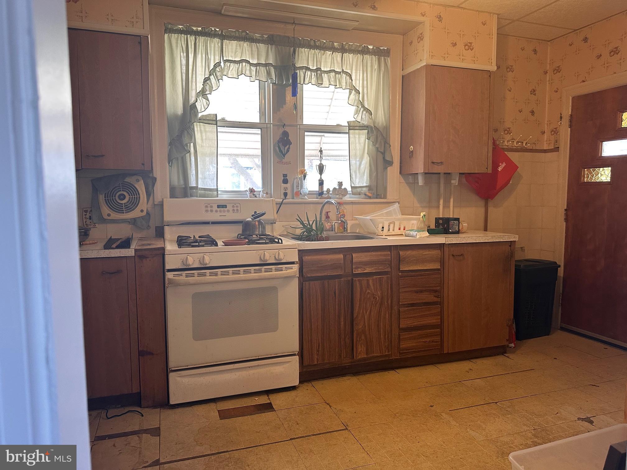 402 Walter Street Philadelphia, PA 19111 - Photo 5 of 15 a kitchen with a sink stove and cabinets