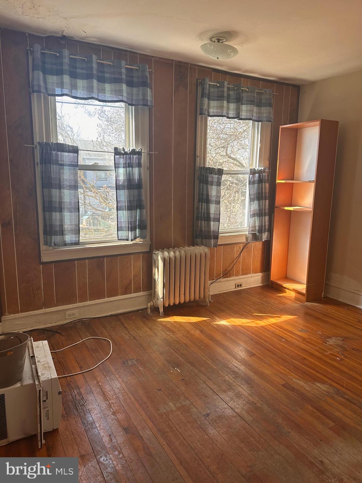 402 Walter Street Philadelphia, PA 19111 - Photo 6 of 15 an empty room with wooden floor and a window