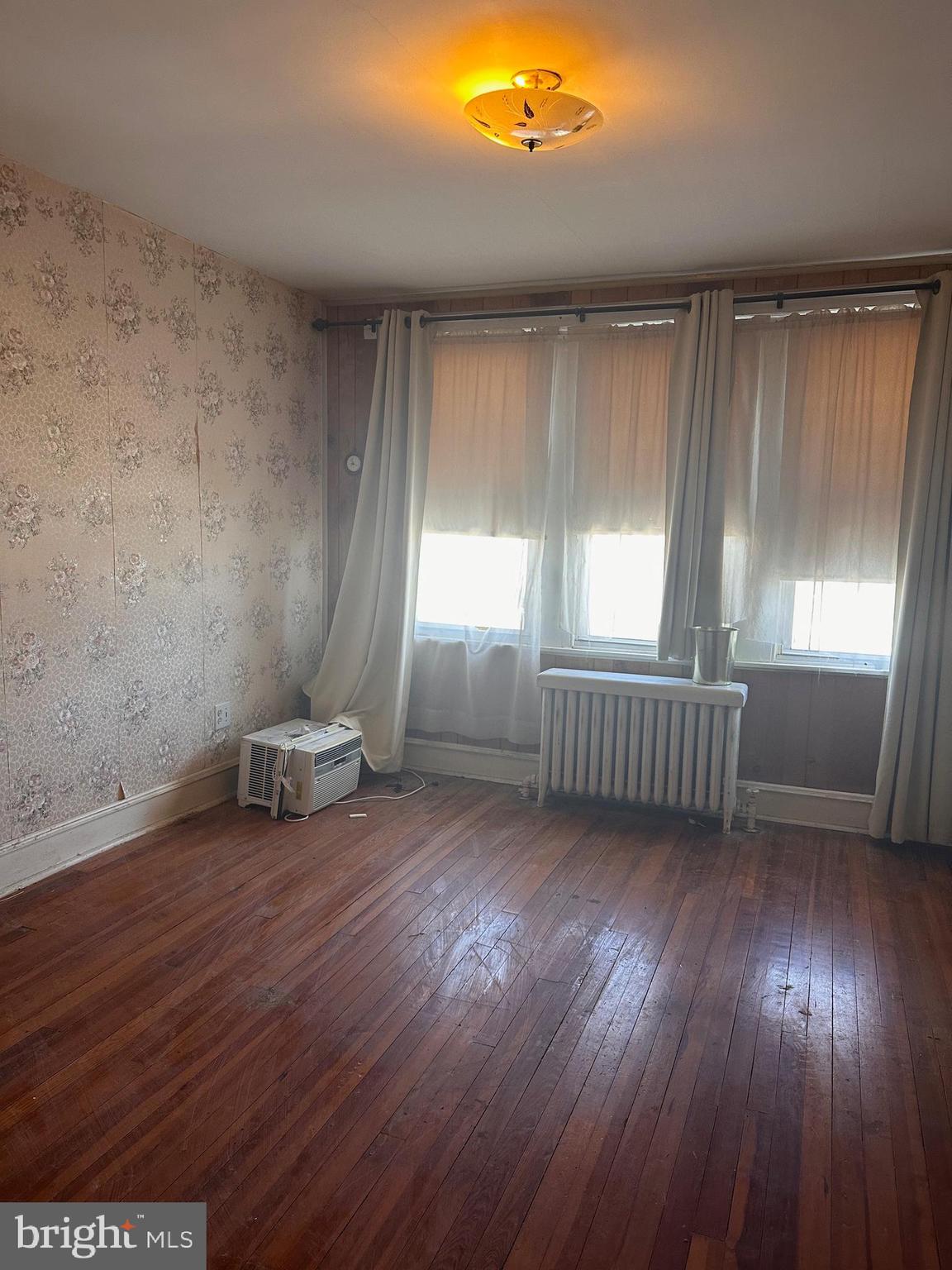 402 Walter Street Philadelphia, PA 19111 - Photo 8 of 15 an empty room with wooden floor and windows