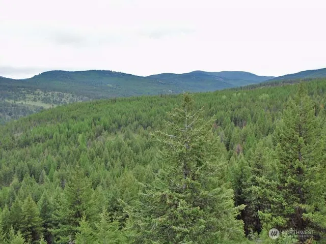 a view of a large mountain with a mountain in the background