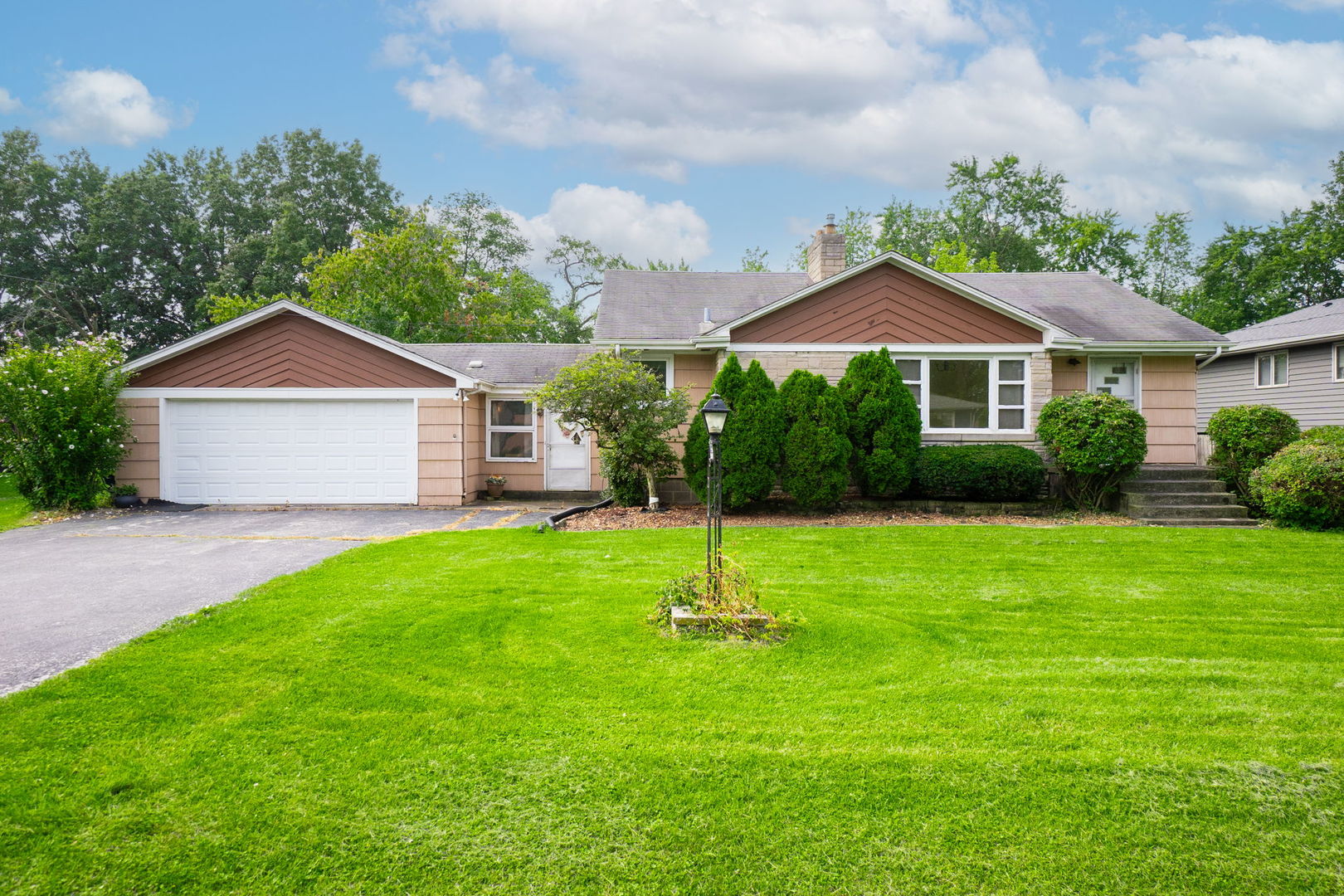 3225 Otto Street Lansing, IL 60438 - Photo 2 of 21 a front view of a house with a yard and green space