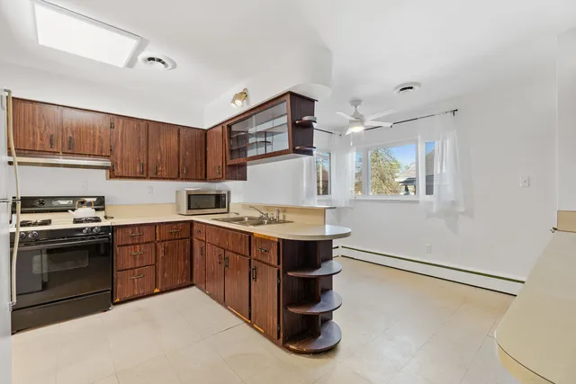 a kitchen with a stove top oven and cabinets