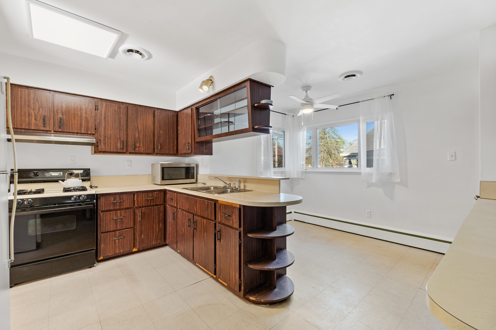 3225 Otto Street Lansing, IL 60438 - Photo 7 of 21 a kitchen with a stove top oven and cabinets