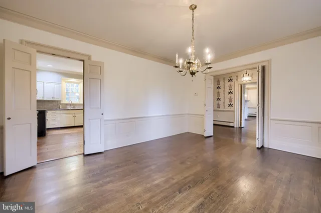 a kitchen with granite countertop a sink cabinets and stainless steel appliances