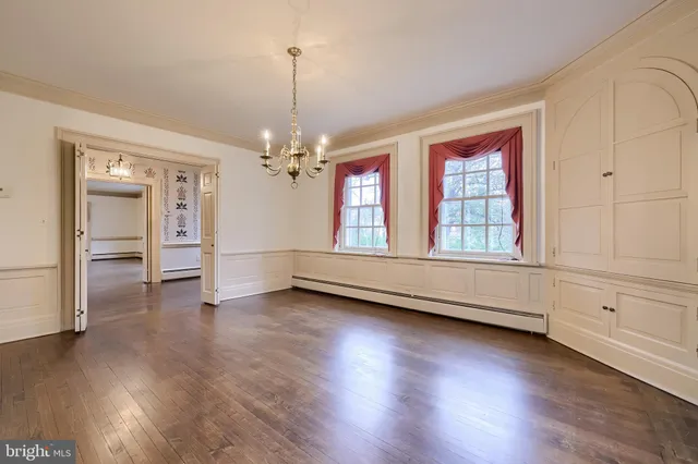 a kitchen with stainless steel appliances a stove a sink and white cabinets