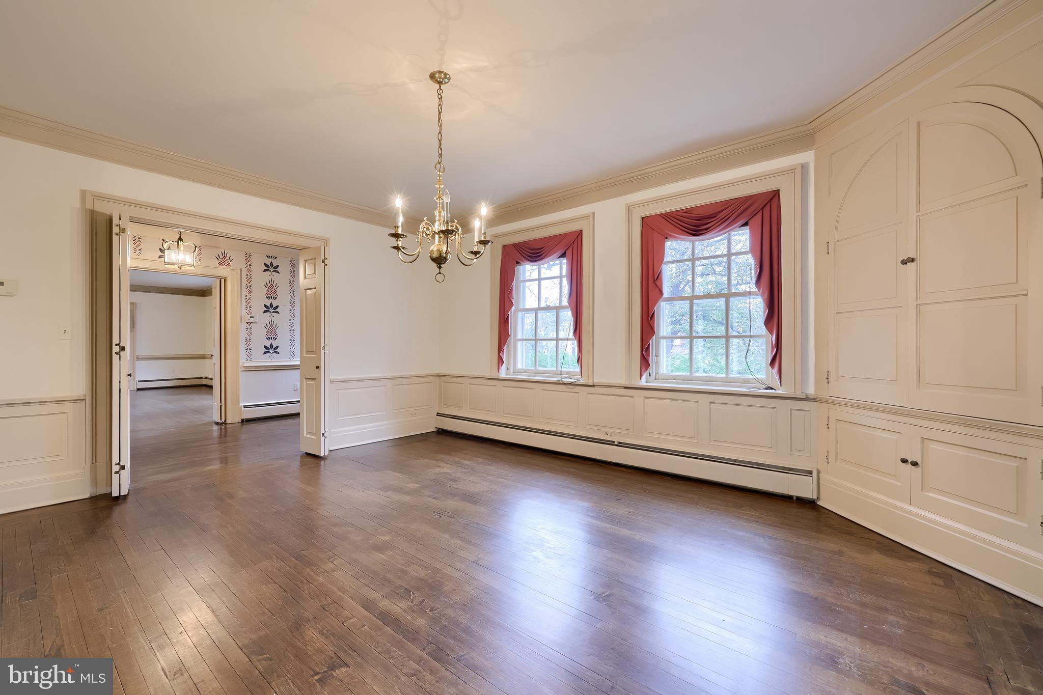 226 East Caracas Avenue Hershey, PA 17033 - Photo 17 of 67 an empty room with wooden floor cabinet and windows