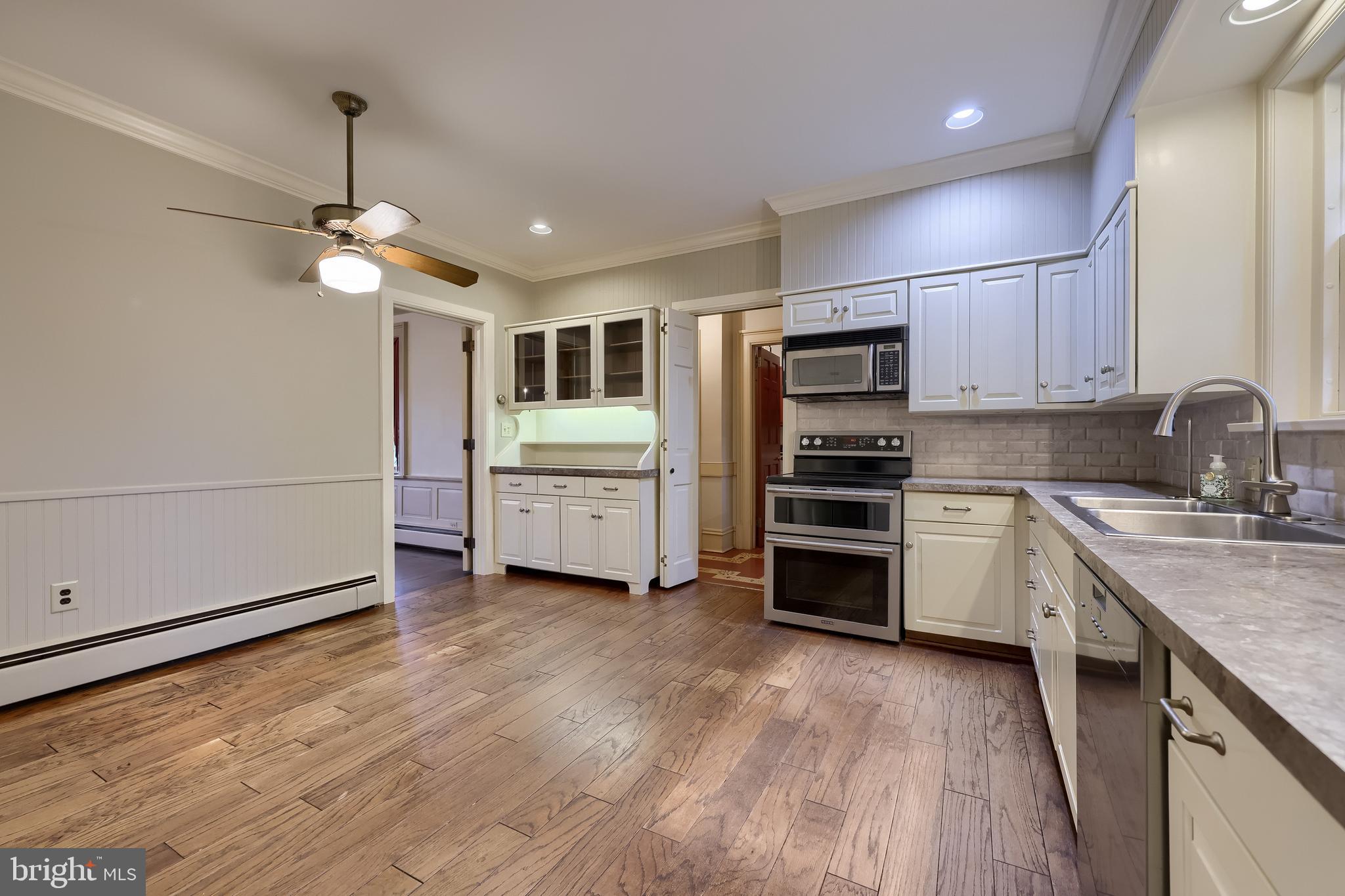 226 East Caracas Avenue Hershey, PA 17033 - Photo 20 of 67 a kitchen with stainless steel appliances a stove a sink and white cabinets