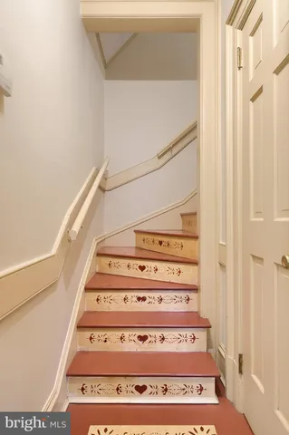 a view of empty room with a fireplace and wooden floor