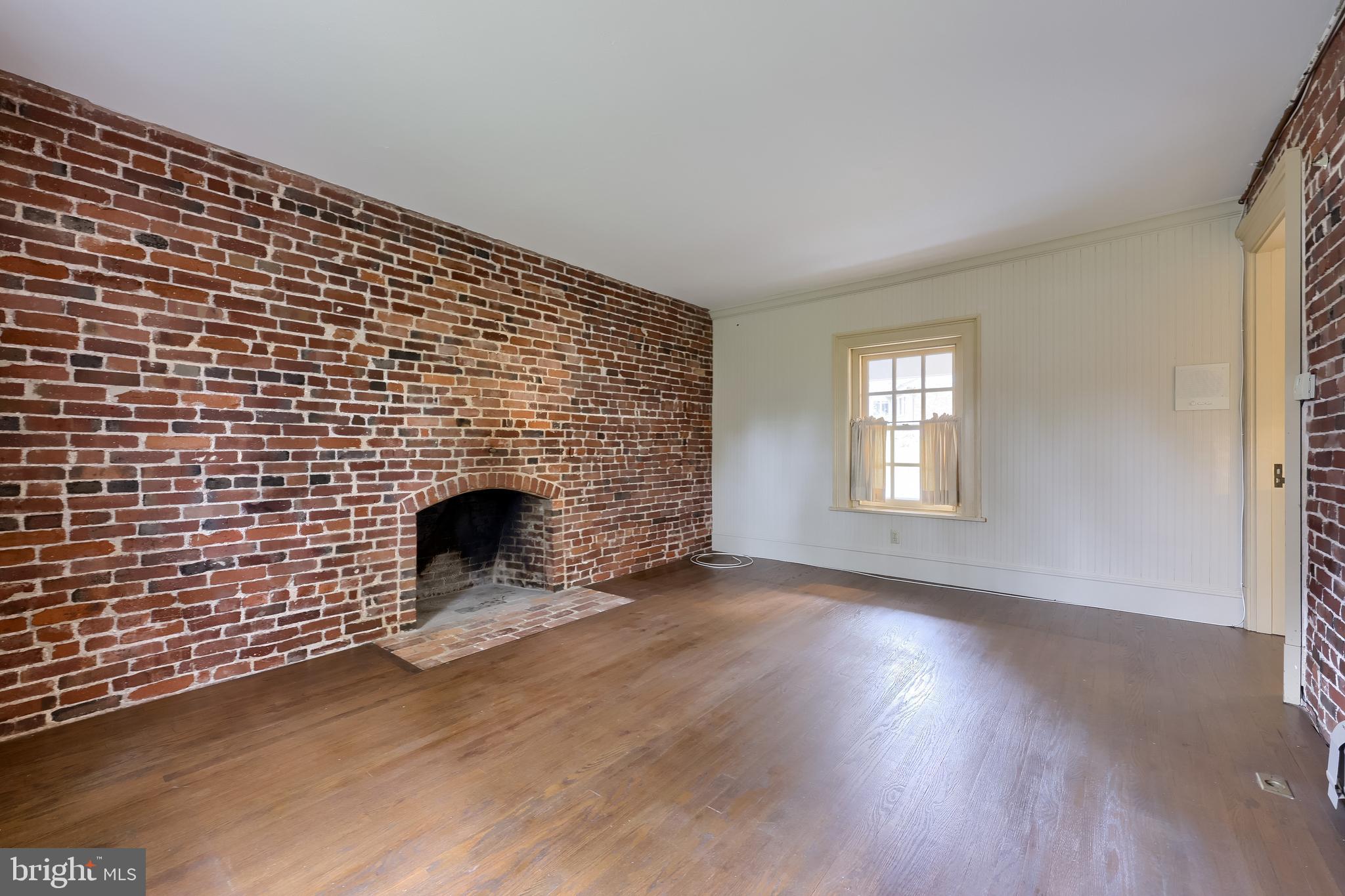 226 East Caracas Avenue Hershey, PA 17033 - Photo 27 of 67 a view of empty room with a fireplace and wooden floor