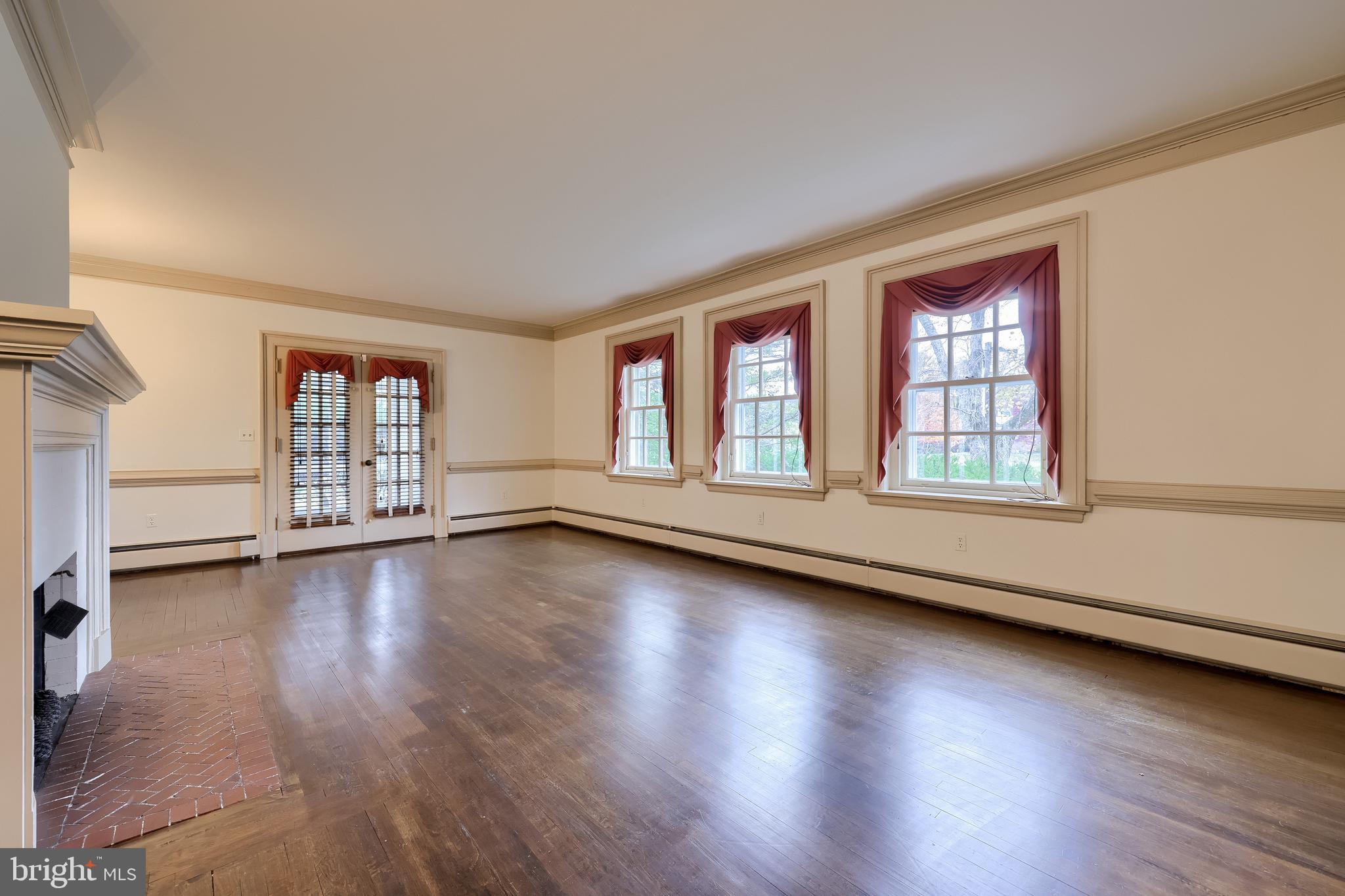 226 East Caracas Avenue Hershey, PA 17033 - Photo 6 of 67 a view of an empty room with wooden floor and window