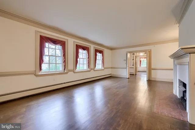 a living room with a fireplace and a chandelier