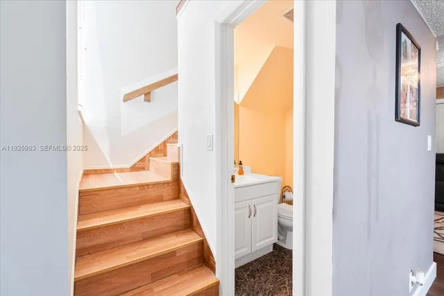 a view of staircase with white walls and a window