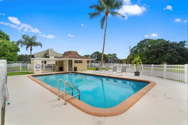 a view of a house with brick walls and a yard with plants