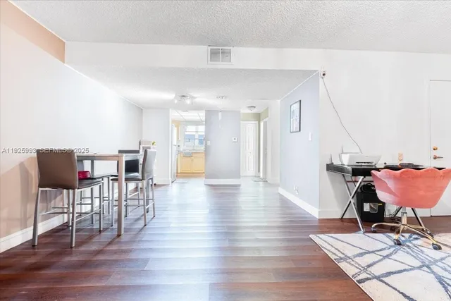 a dining room with furniture and wooden floor