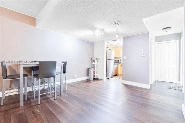 a view of a livingroom with furniture wooden floor and front door