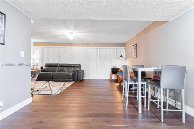 a living room with furniture and kitchen view
