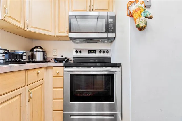 a kitchen with a stove and a white cabinets
