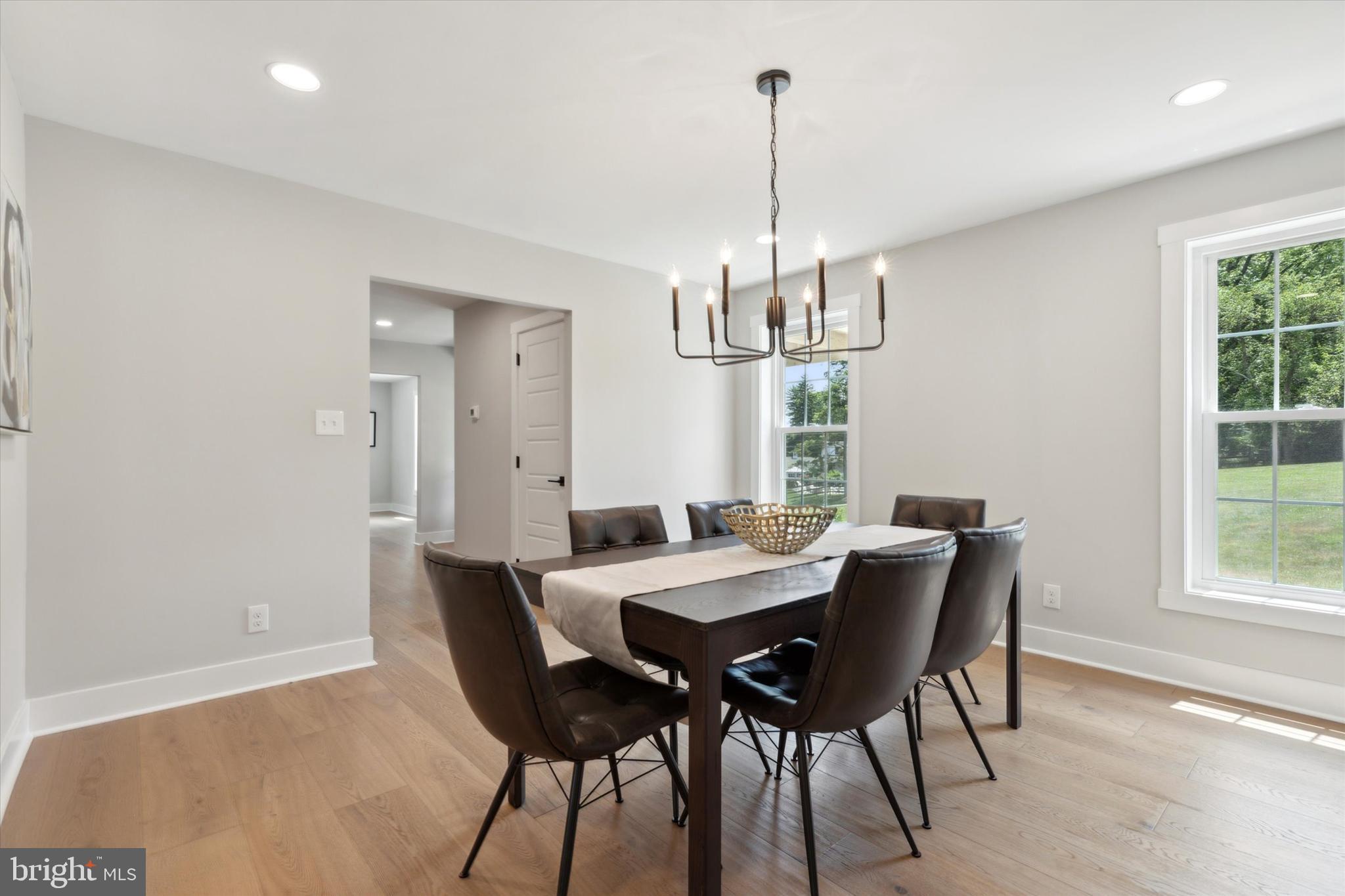607 Golf Club Road Newtown Square, PA 19073 - Photo 13 of 86 a view of a dining room with furniture a chandelier and wooden floor