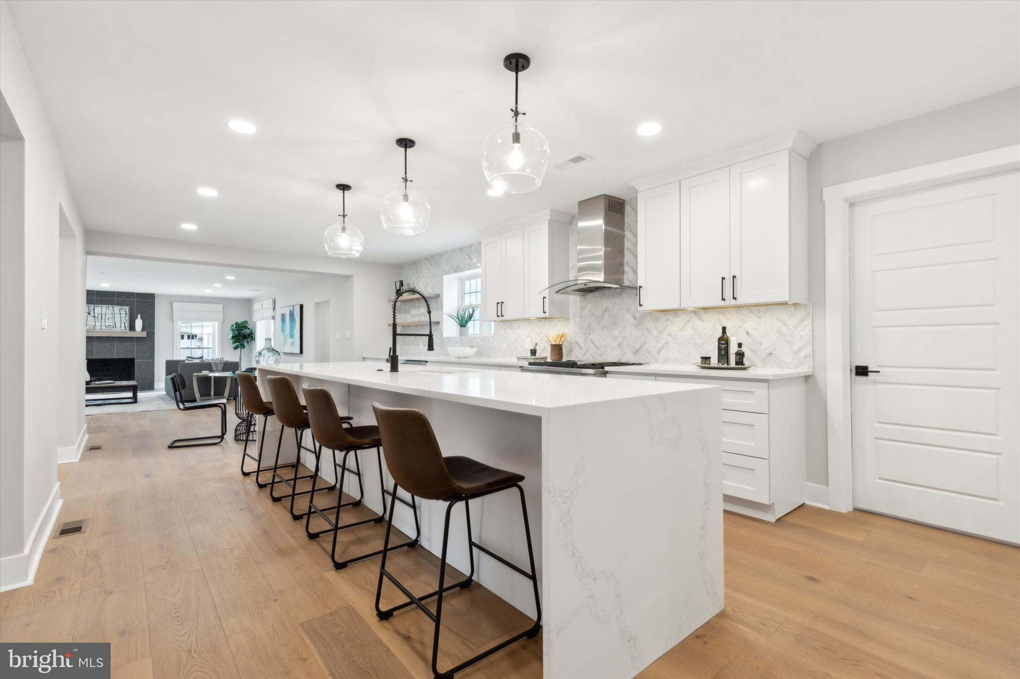 607 Golf Club Road Newtown Square, PA 19073 - Photo 16 of 86 a kitchen with kitchen island granite countertop a sink cabinets and wooden floor