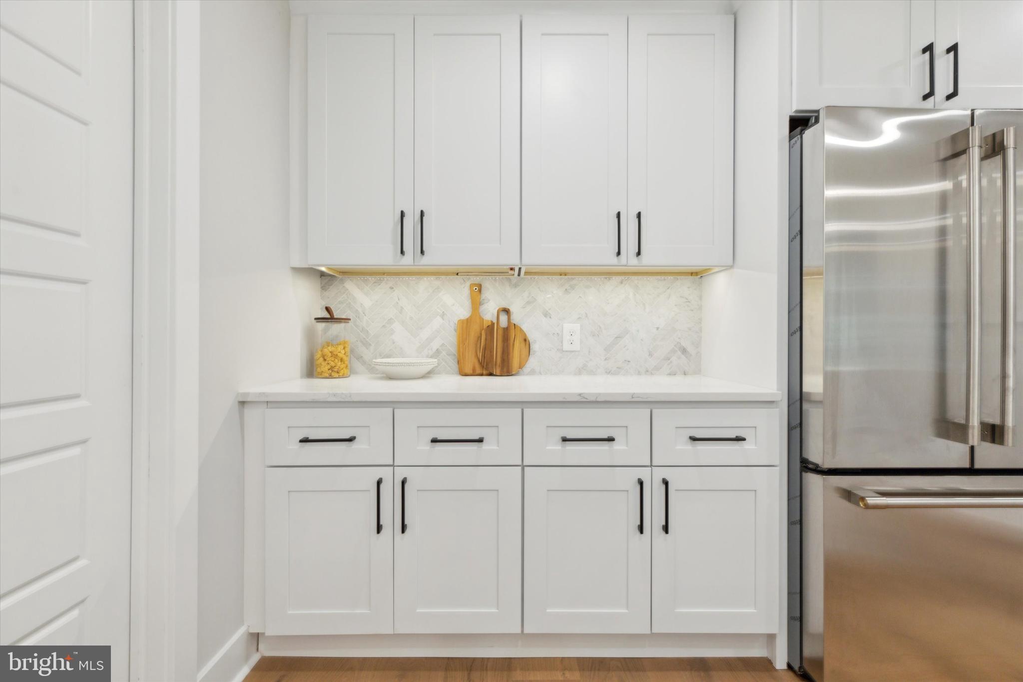 607 Golf Club Road Newtown Square, PA 19073 - Photo 21 of 86 a kitchen with white cabinets and refrigerator