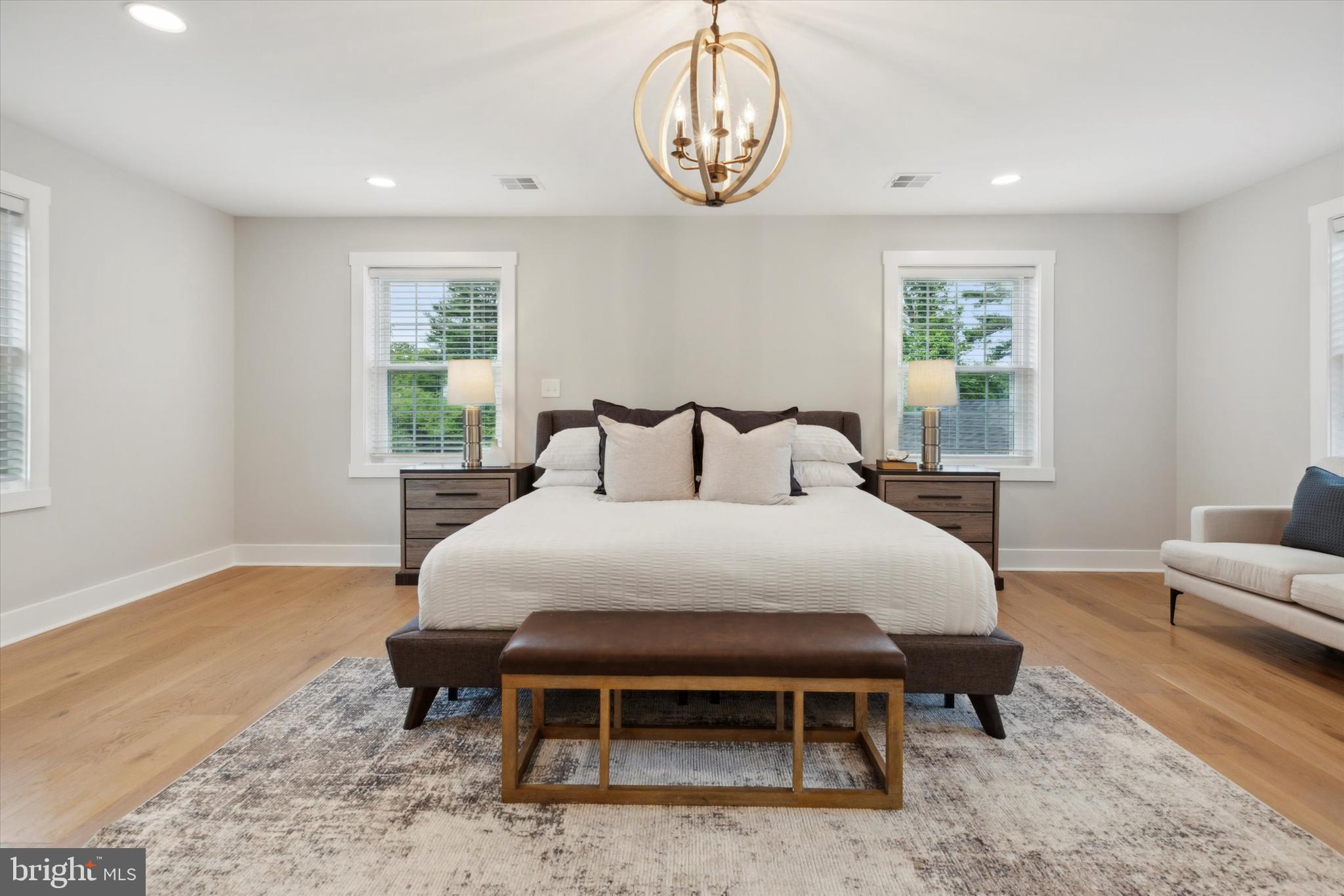 607 Golf Club Road Newtown Square, PA 19073 - Photo 39 of 86 a bedroom with a bed a chandelier and a window