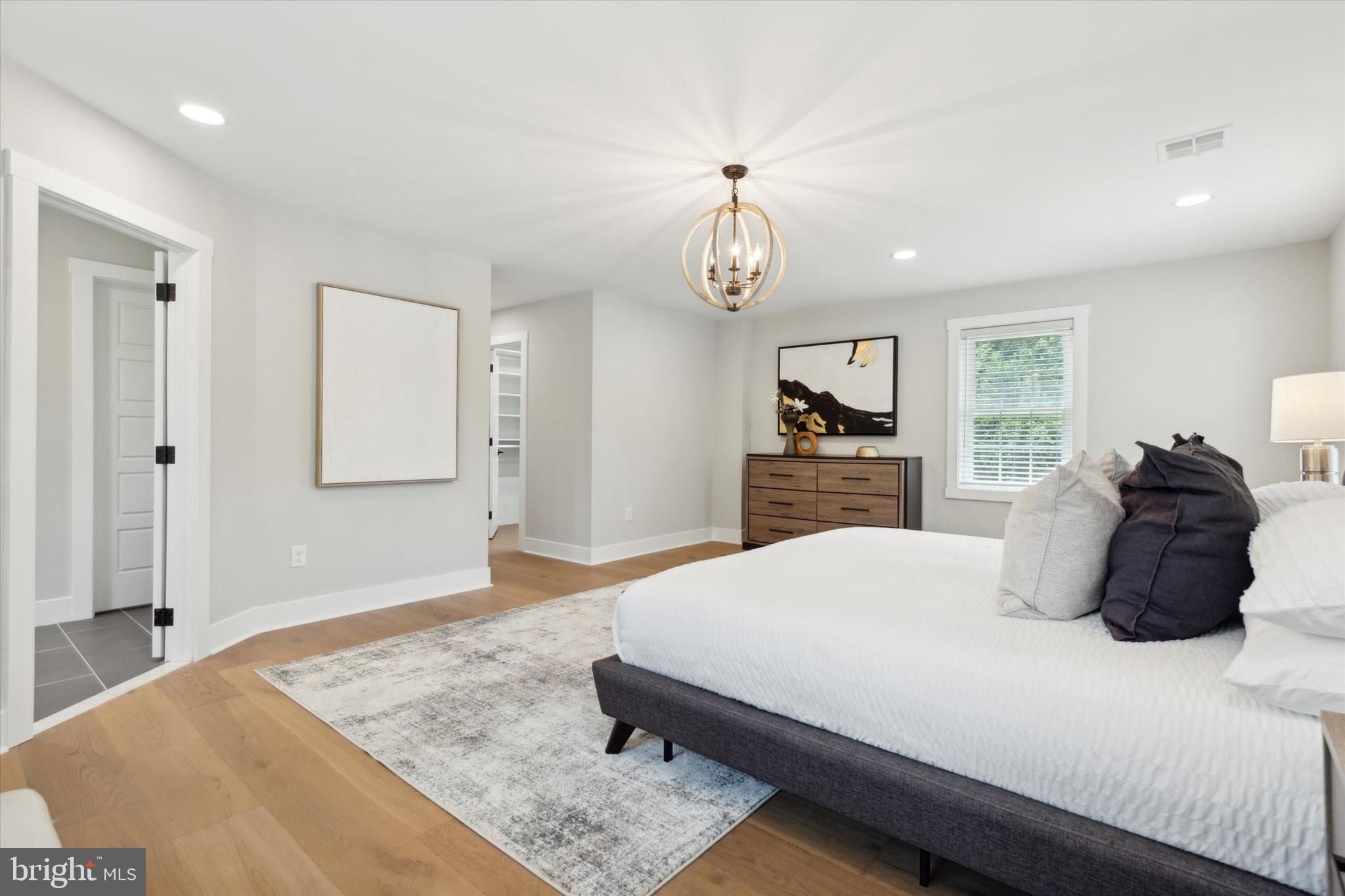 607 Golf Club Road Newtown Square, PA 19073 - Photo 43 of 86 a bedroom with a bed and dresser with mirror