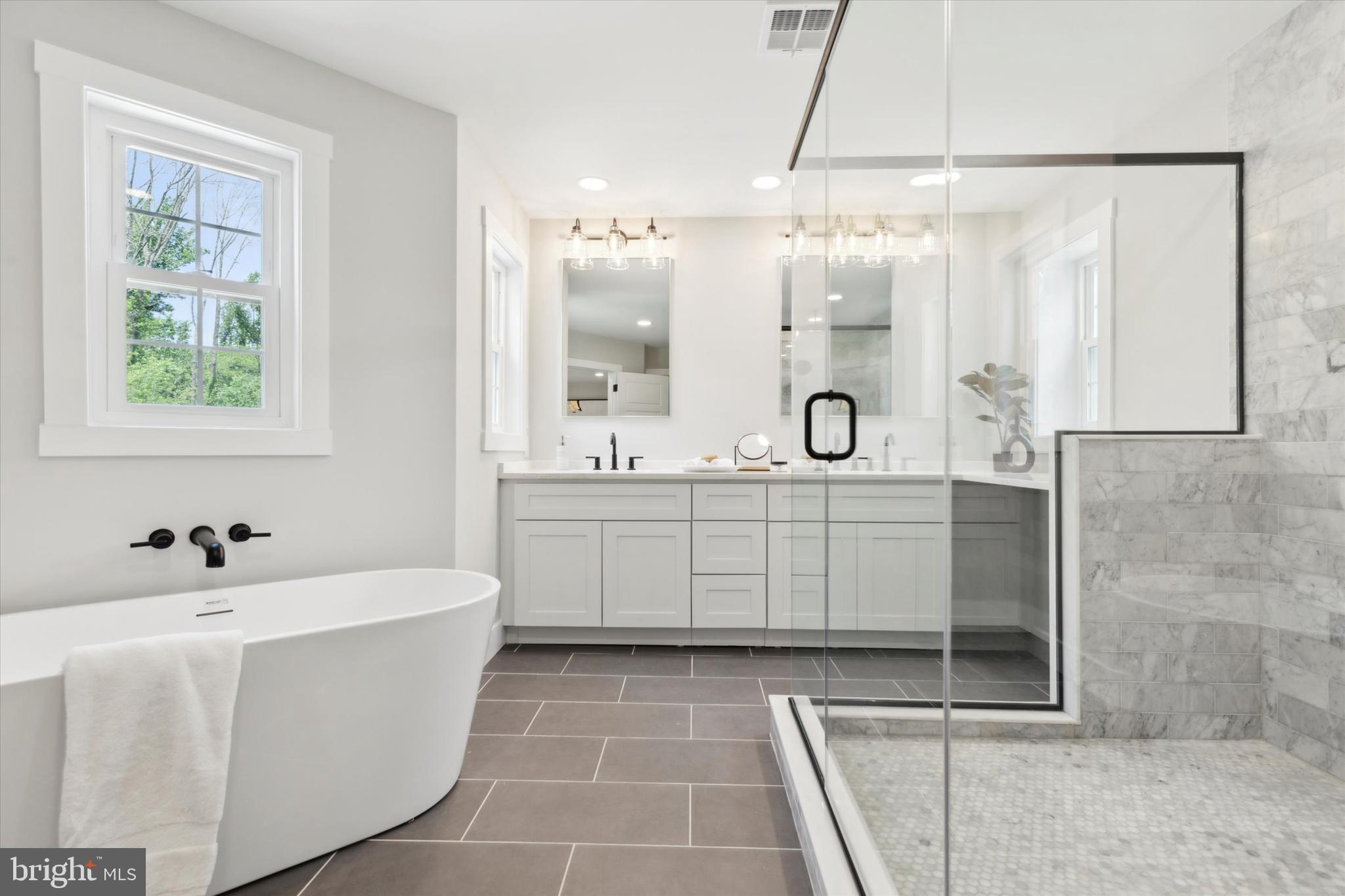 607 Golf Club Road Newtown Square, PA 19073 - Photo 44 of 86 a bathroom with a double vanity sink mirror and bathtub