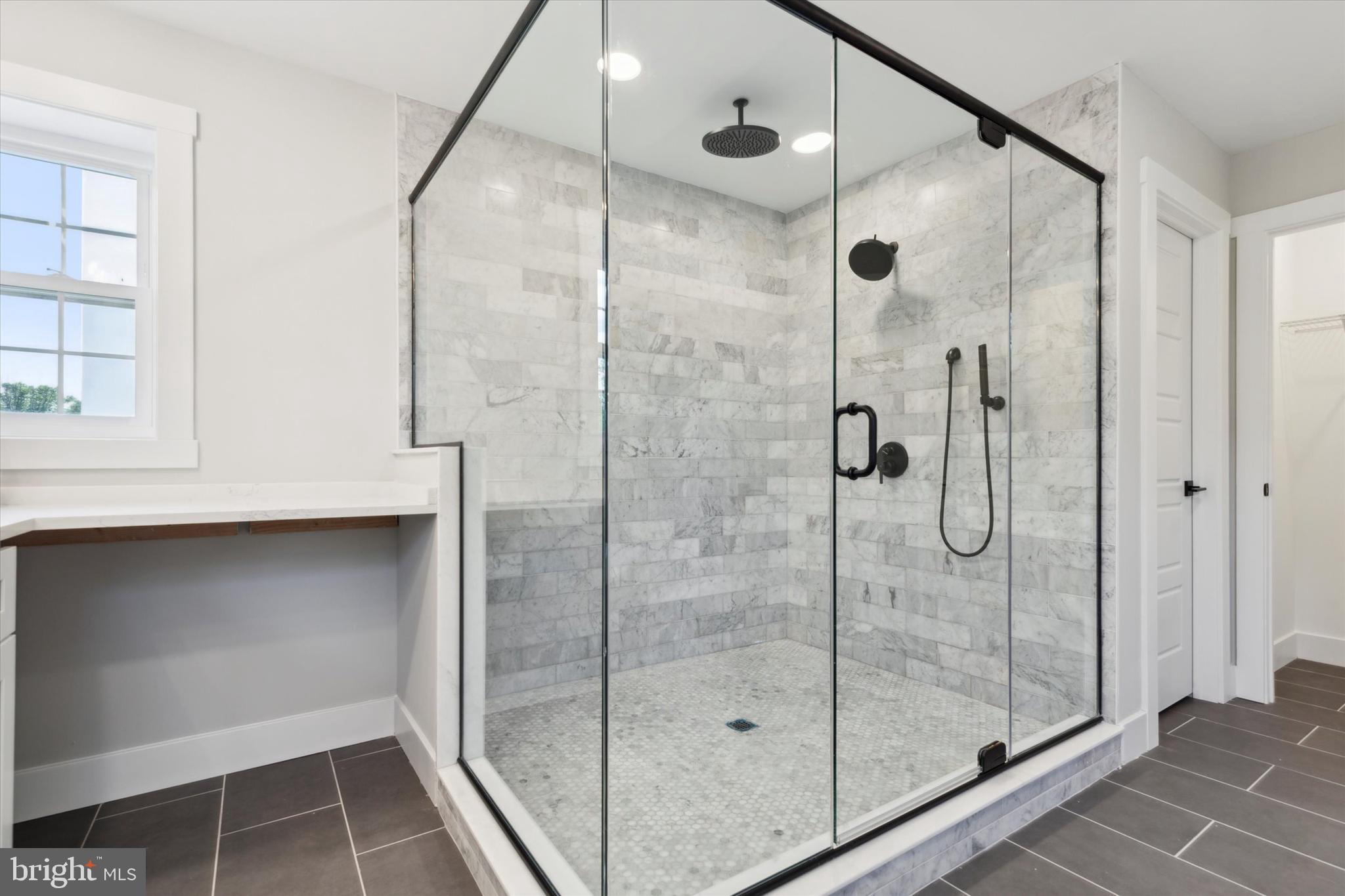 607 Golf Club Road Newtown Square, PA 19073 - Photo 49 of 86 a bathroom with a shower and a window