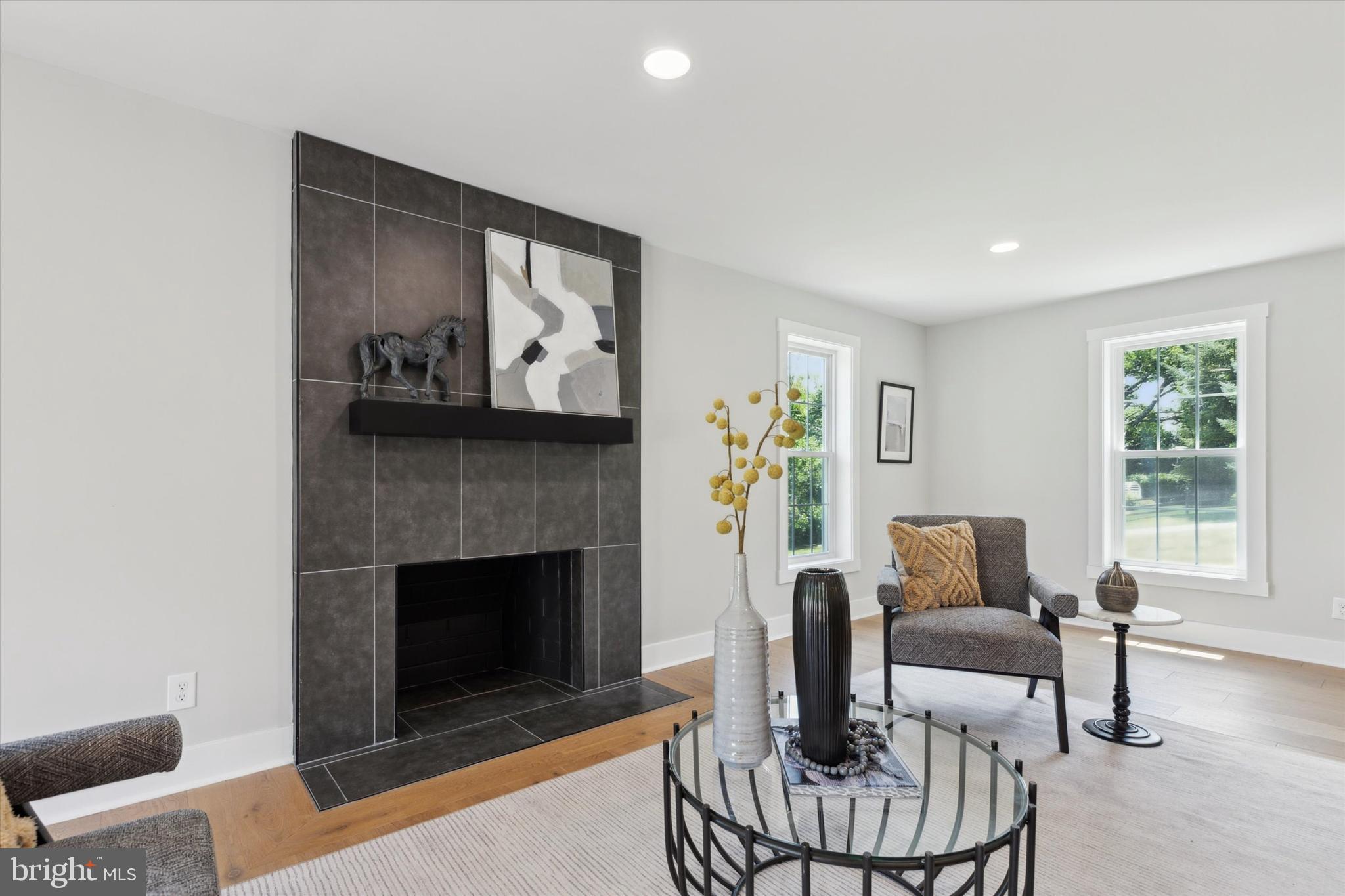 607 Golf Club Road Newtown Square, PA 19073 - Photo 8 of 86 a living room with furniture a fireplace and a table
