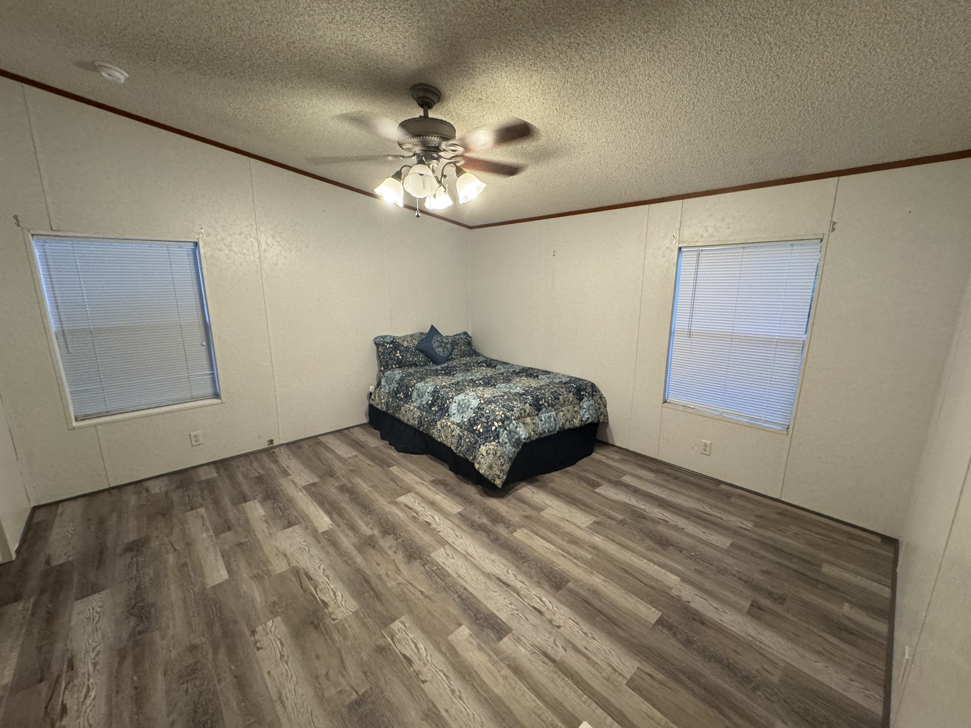 70 Timber Road Point Blank, TX 77364 - Photo 16 of 20 a living room with a bed furniture and a ceiling fan