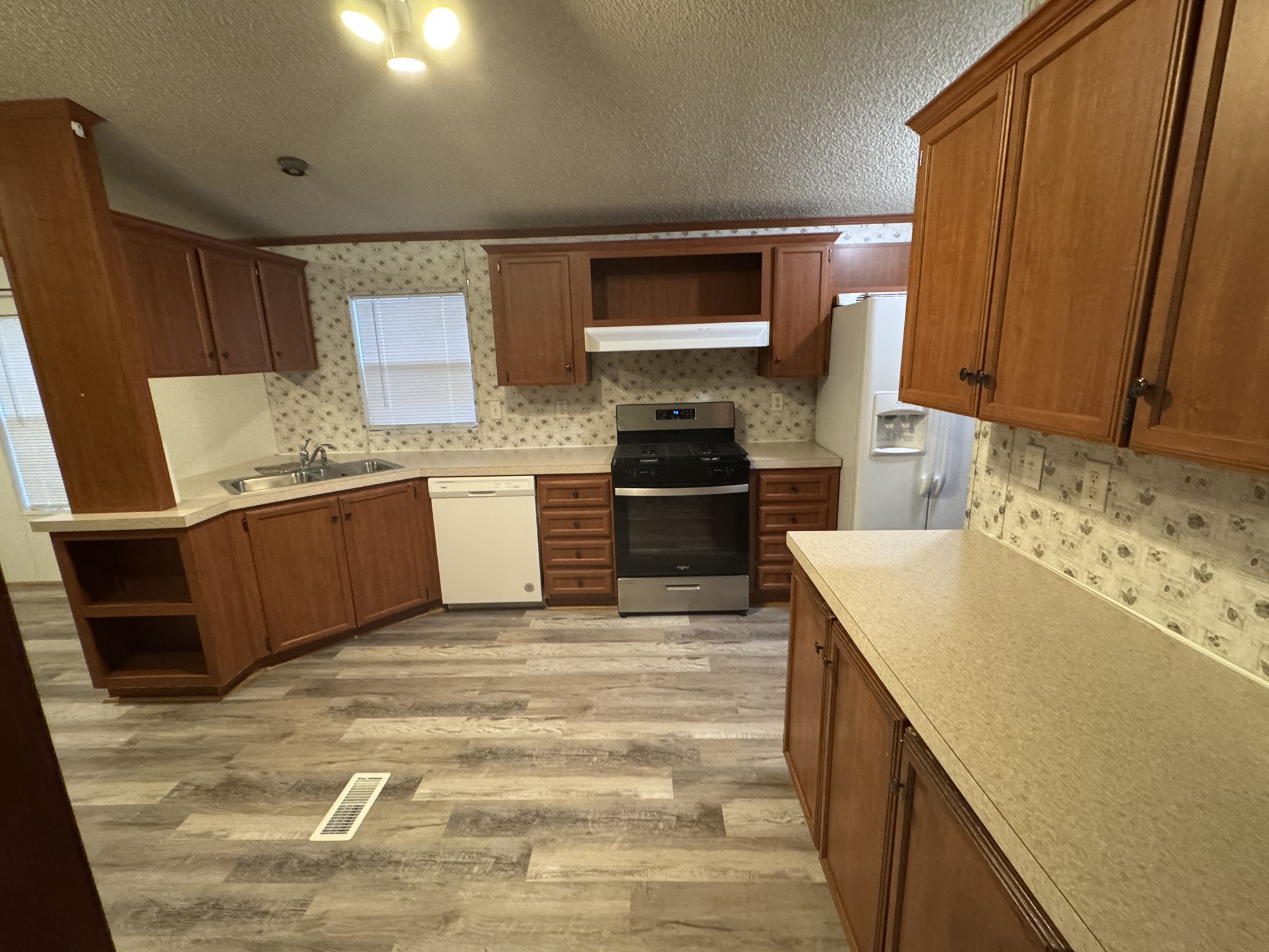 70 Timber Road Point Blank, TX 77364 - Photo 5 of 20 a kitchen with stainless steel appliances granite countertop a sink stove and refrigerator