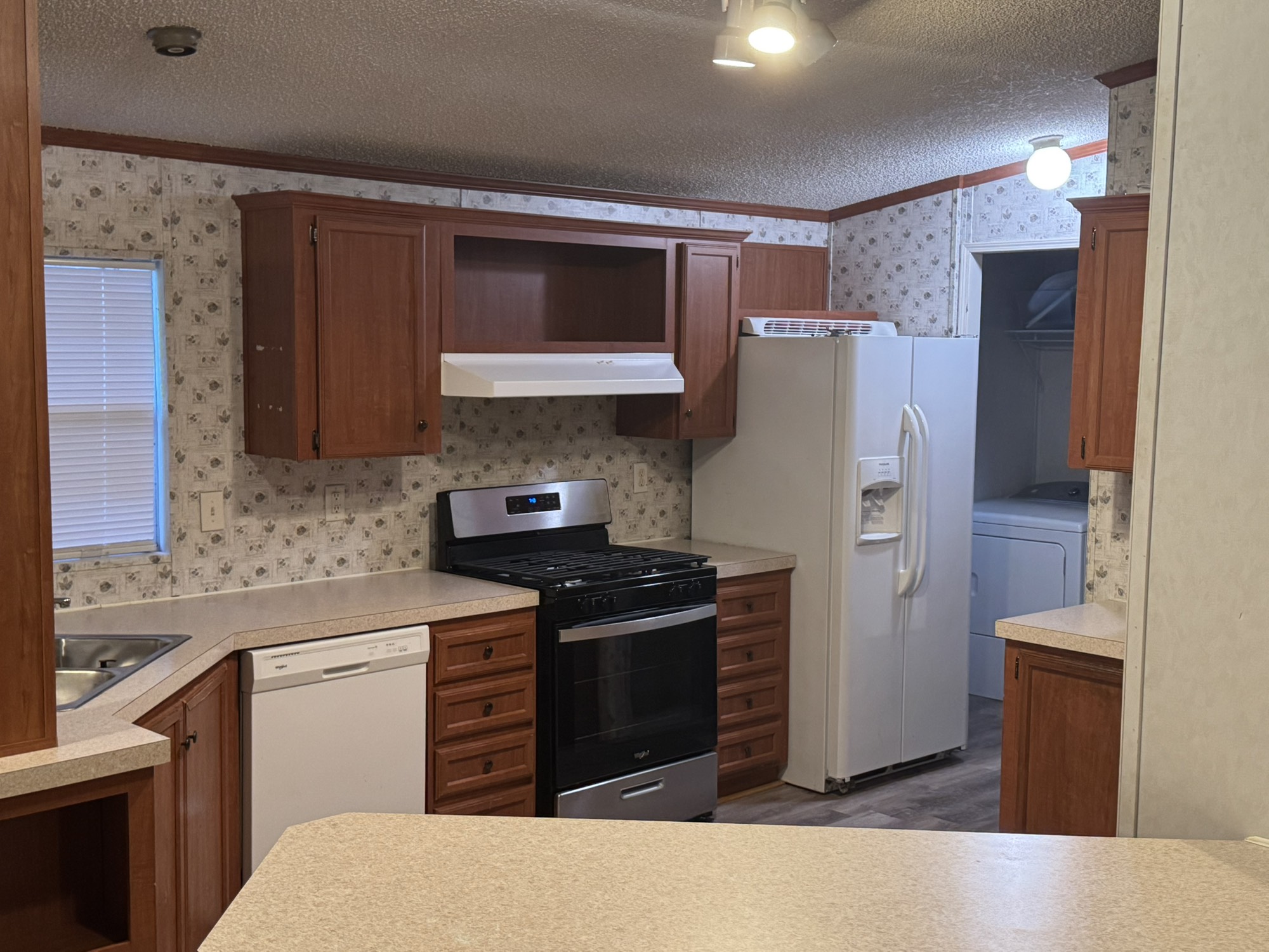 70 Timber Road Point Blank, TX 77364 - Photo 7 of 20 a kitchen with a refrigerator sink and cabinets