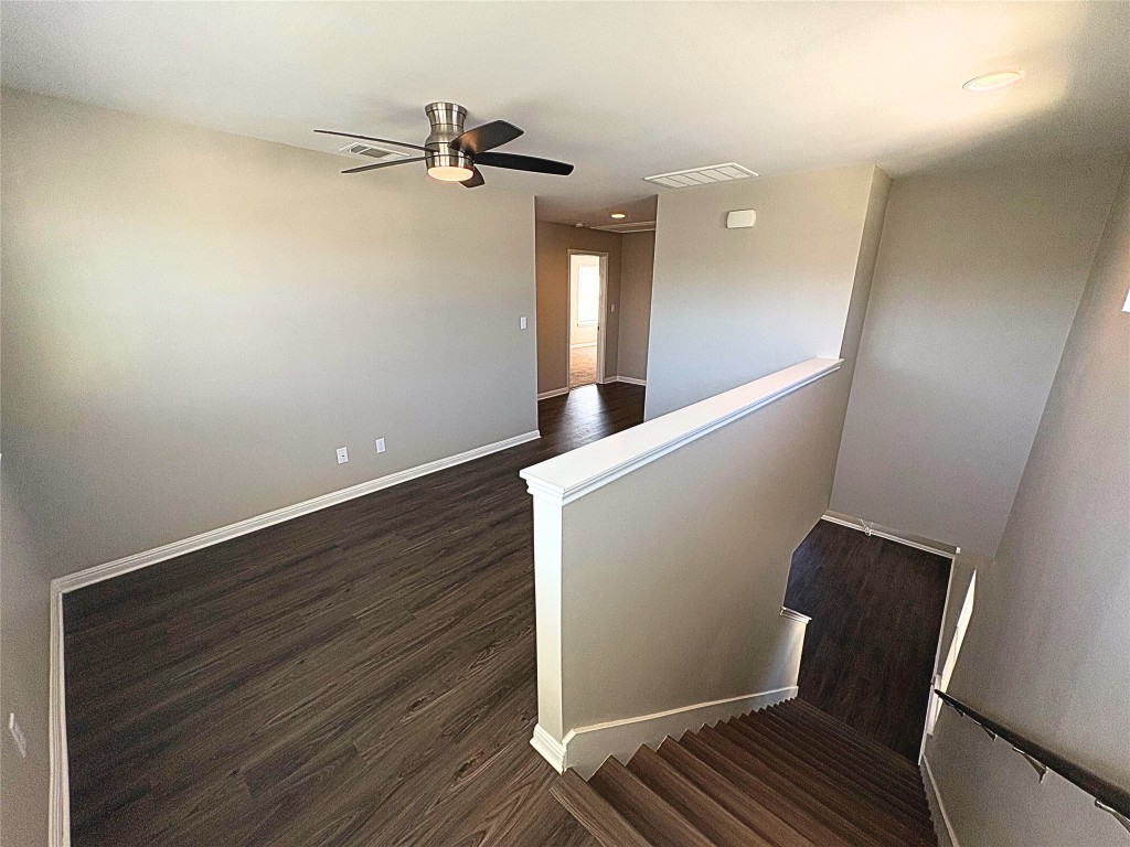 240 Arabian Colt Drive Georgetown, TX 78626 - Photo 14 of 25 a view of an empty room with wooden floor and a window