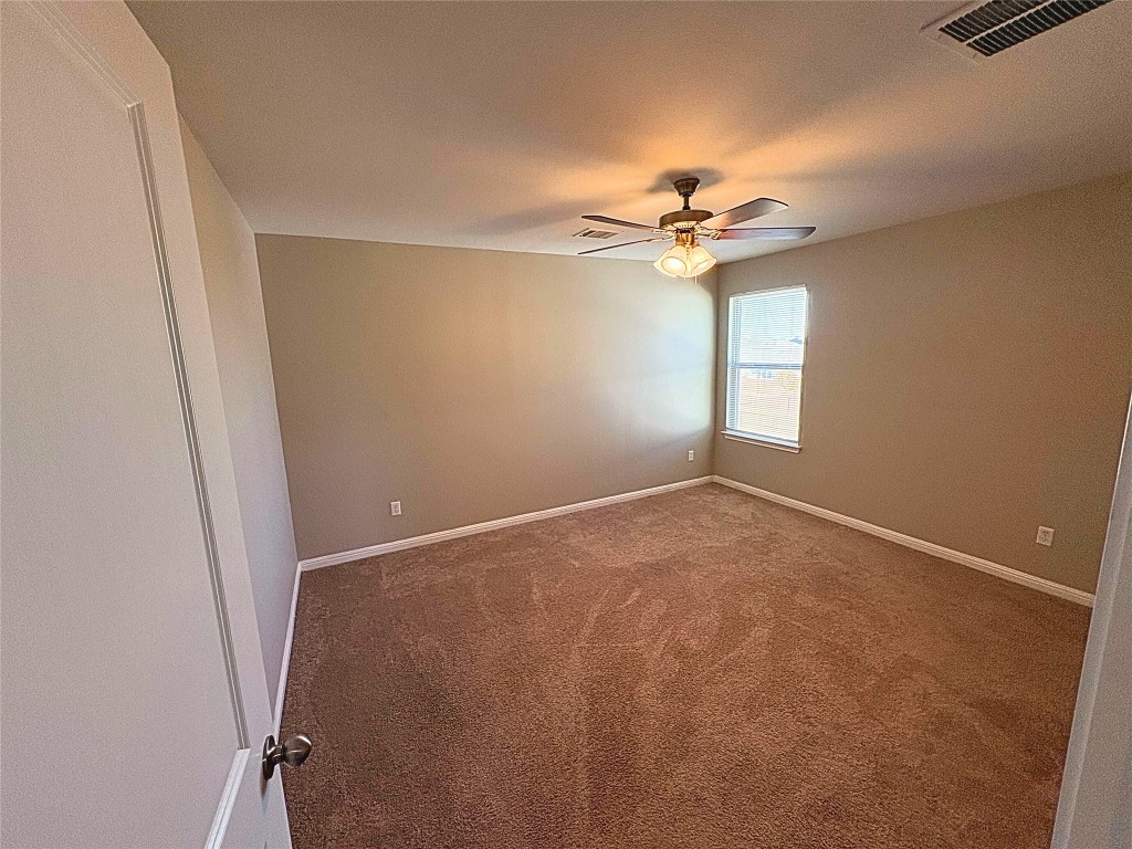 240 Arabian Colt Drive Georgetown, TX 78626 - Photo 17 of 25 an empty room with windows and fan