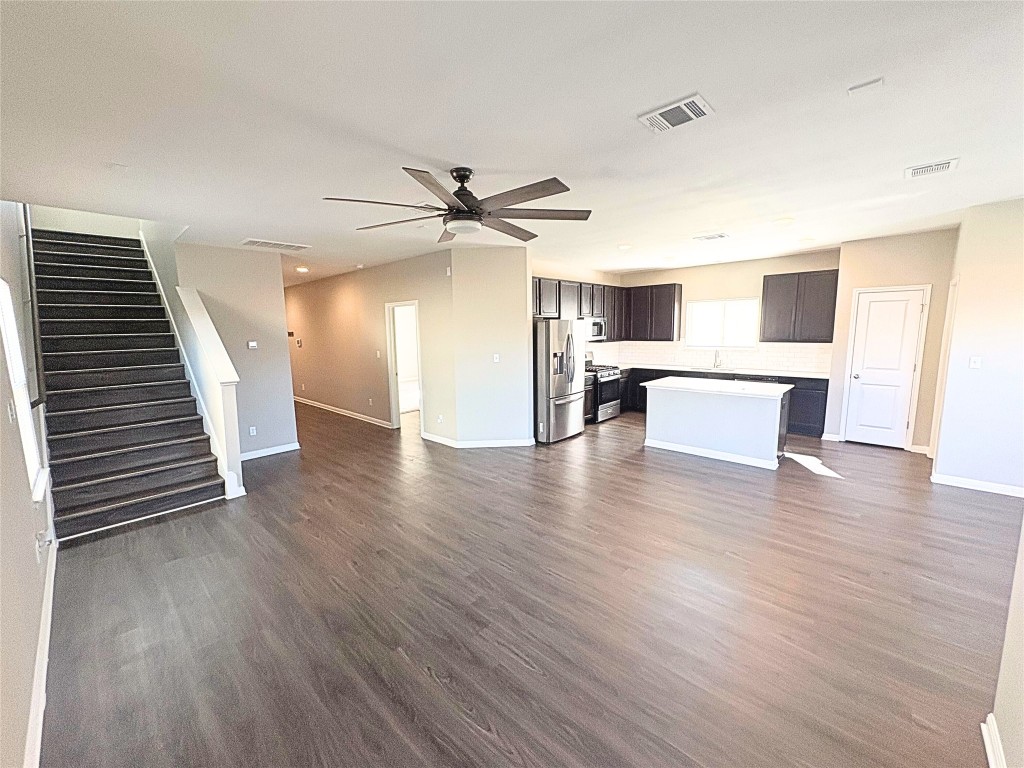 240 Arabian Colt Drive Georgetown, TX 78626 - Photo 5 of 25 a view of a living room a kitchen and a wooden floor