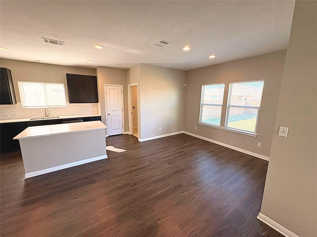 240 Arabian Colt Drive Georgetown, TX 78626 - Photo 6 of 25 a view of an empty room with wooden floor and a window