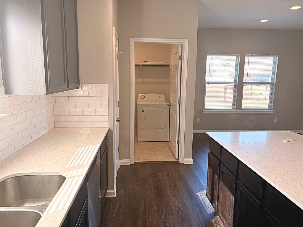 240 Arabian Colt Drive Georgetown, TX 78626 - Photo 8 of 25 a kitchen with a sink cabinets and wooden floor