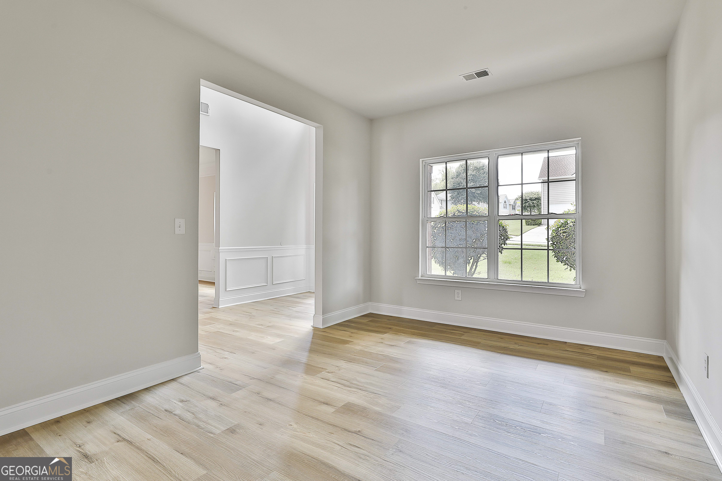 28 Fox Ridge Drive Newnan, GA 30265 - Photo 12 of 48 a view of an empty room with wooden floor and a window