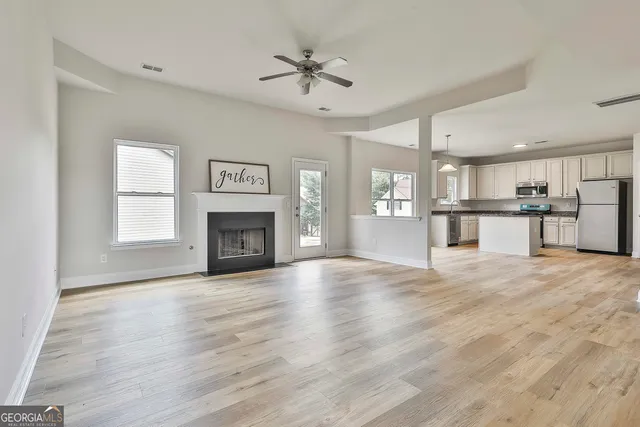 a view of a kitchen with a sink and a fireplace