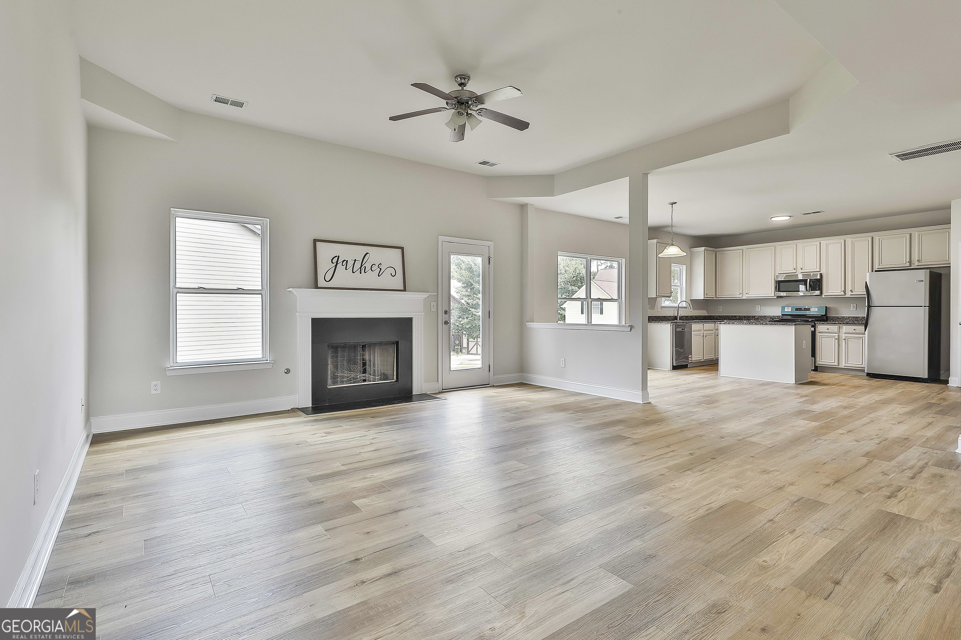 28 Fox Ridge Drive Newnan, GA 30265 - Photo 14 of 48 a view of a kitchen with a sink and a fireplace