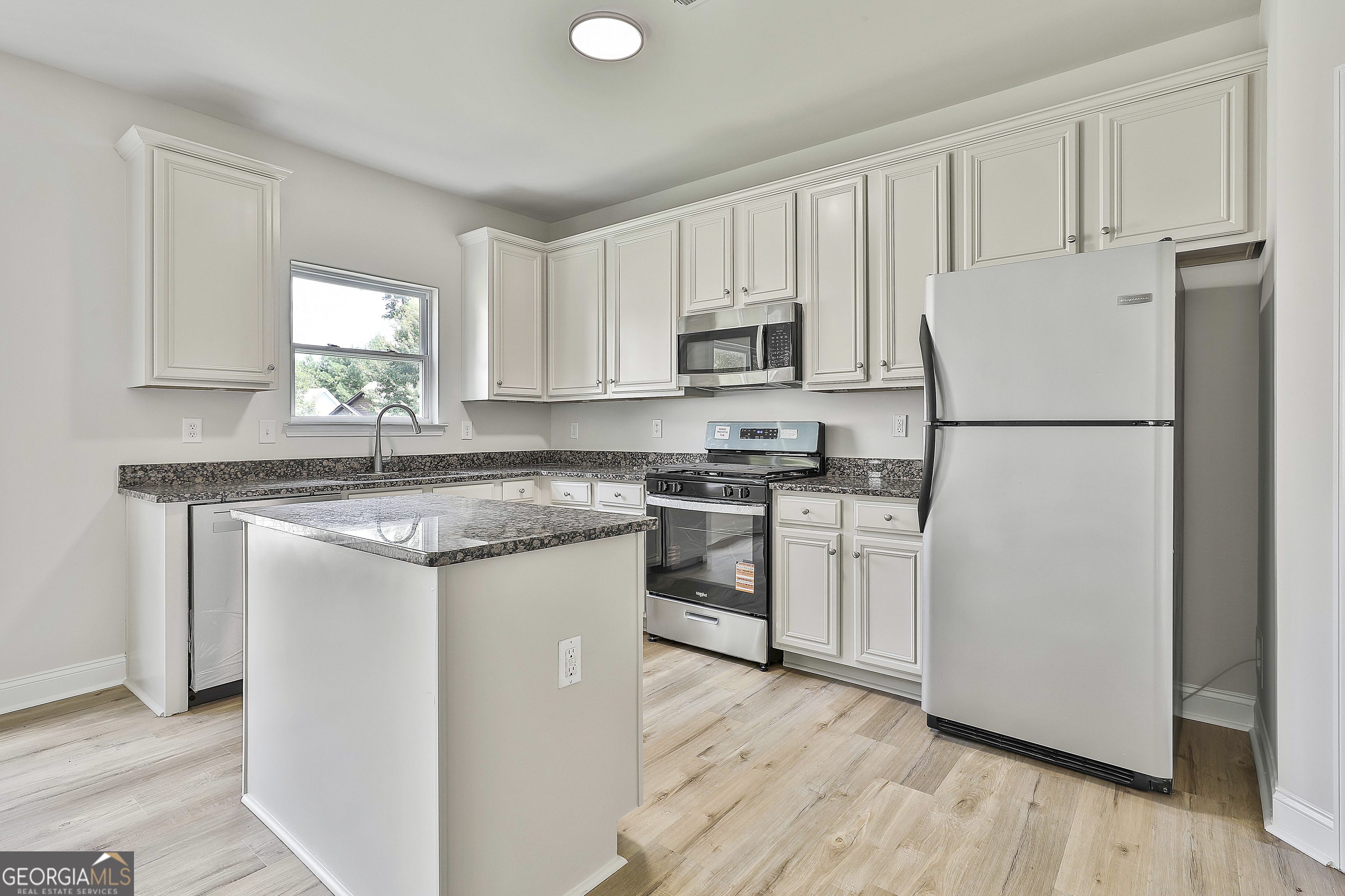 28 Fox Ridge Drive Newnan, GA 30265 - Photo 19 of 48 a kitchen with white cabinets white appliances and sink