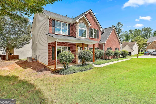 a front view of a house with a yard